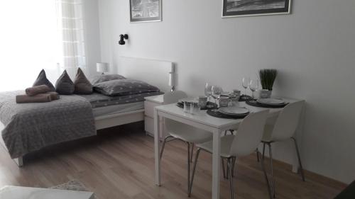 a bedroom with a bed and a table and chairs at Apartament 22 nad morzem in Świnoujście