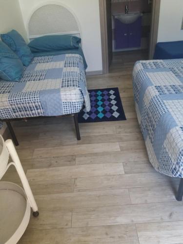 a bedroom with two beds and a chessboard on the floor at For Ever Apartments in Fiumicino