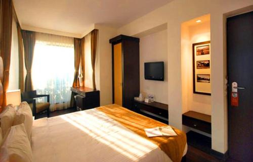 Postel nebo postele na pokoji v ubytování Hotel Metropole