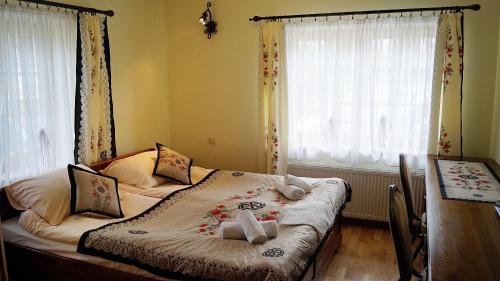 a bedroom with a bed with flowers on it at Willa Tatrzański Zomecek in Kościelisko