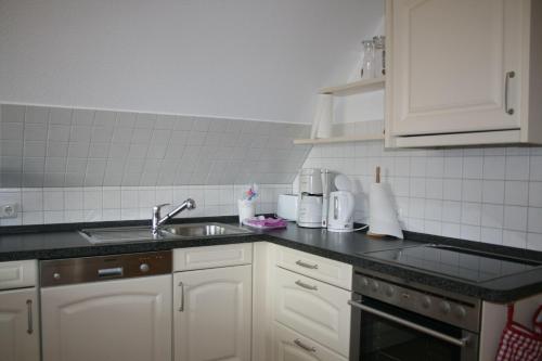 a kitchen with a sink and a counter top at Nickelshus-Whg-Lars in Sankt Peter-Ording