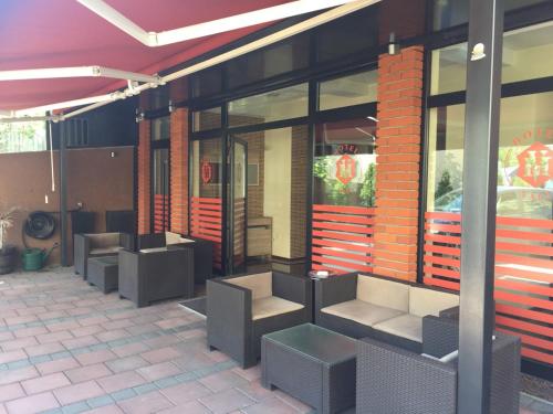 a row of benches outside of a fast food restaurant at Hotel Millenium2 in Prizren