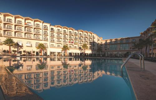 a large building with a pool of water in front of it at Vila Gale Santa Cruz in Santa Cruz