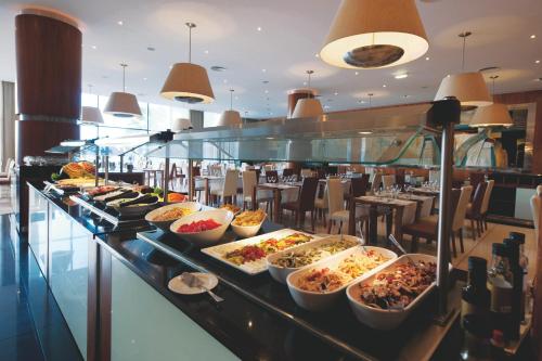 a buffet line with many different dishes of food at Vila Gale Santa Cruz in Santa Cruz