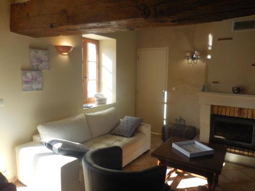 a living room with a couch and a table at les gîtes de l'argenterie à 15km du zoo de Beauval classés 4 étoiles in Fontguenand