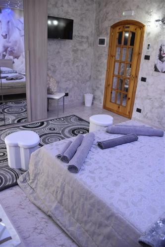 a bed with purple pillows on it in a room at Il Cuore dell'Etna in Belpasso