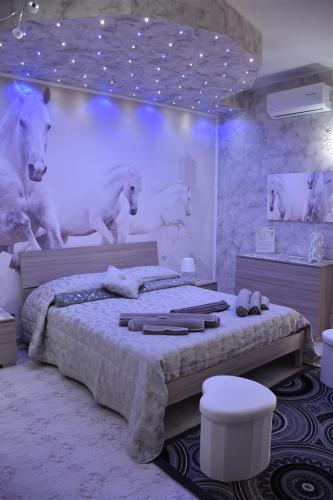 a bedroom with a bed with a mural of wolves at Il Cuore dell'Etna in Belpasso