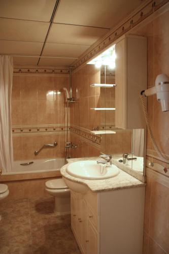 a bathroom with a sink and a toilet and a shower at Apartamentos Imperial in Salou