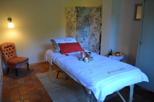 a bed in a room with a table and a chair at La Longère d'Ecottes in Licques