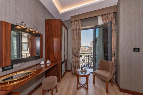 a bathroom with a vanity and a mirror and a balcony at Piya Sport Hotel in Istanbul