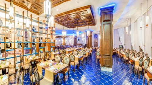 a dining room filled with tables and chairs at Granada Luxury Belek - Family Kids Concept in Belek