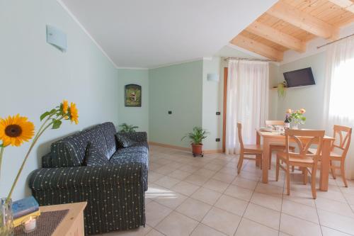 a living room with a couch and a table at Residence Hotel Raggio Di Luce in Ponte di Legno