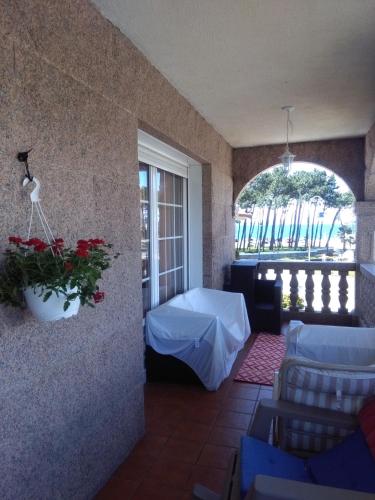 a room with a table and chairs and a window at piso chalet en playa samil in Vigo