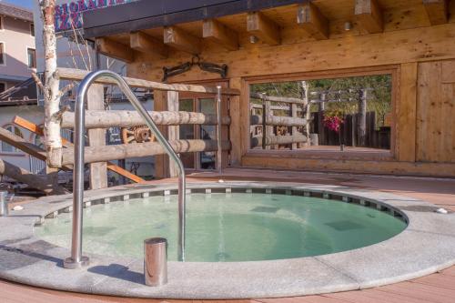 a hot tub in the middle of a wooden building at La Torretta in Passo del Tonale