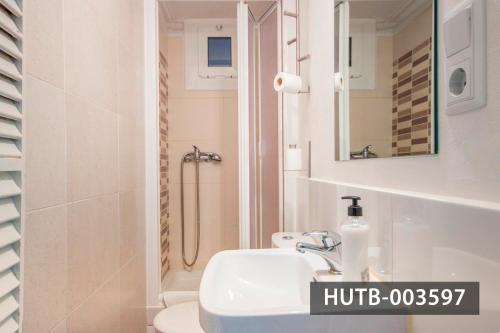 a white bathroom with a sink and a shower at Big Apartment Barcelona Gran via in Barcelona