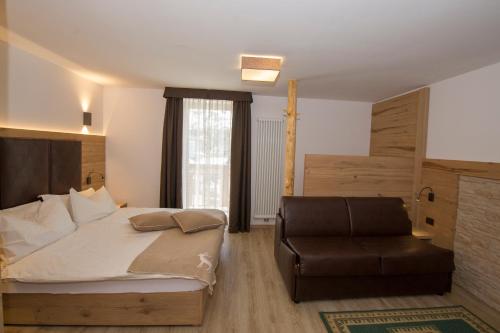 a bedroom with a bed and a chair at La Torretta in Passo del Tonale