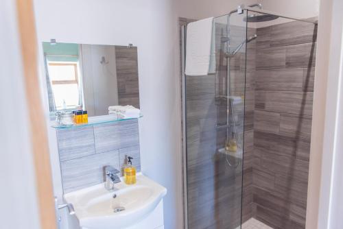 a bathroom with a sink and a shower at The Haughmond in Shrewsbury