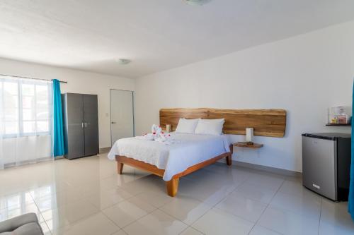 a bedroom with a bed and a television in it at Hotel IBIZA Beach Boutique in Jacó