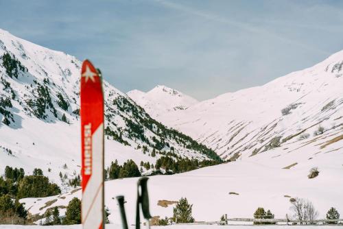 a red sign in the snow with mountains in the background at Hotel Macun, Vent im Ötztal in Vent