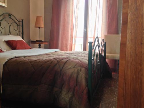 a bedroom with a bed and a window at Hotel Mignon in Trieste
