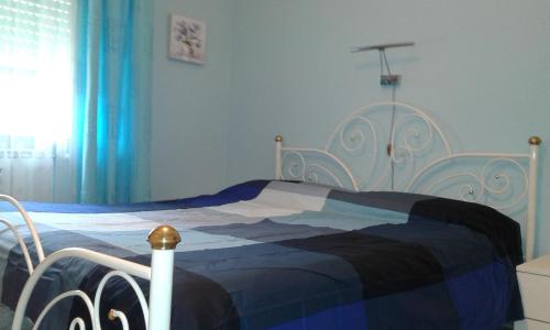 A bed or beds in a room at Appartamento Lauretta