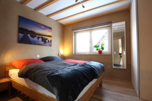 a bedroom with a bed and a window at Graues Haus in Monschau