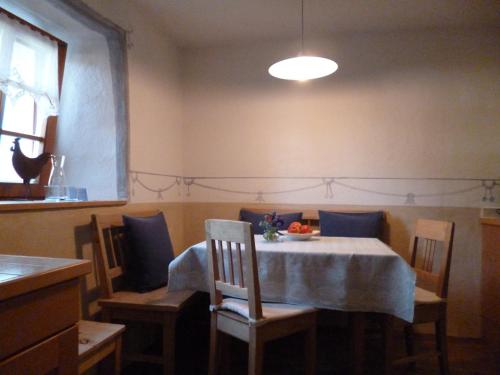 a dining room with a table and chairs and a window at Landhaus Strickenmacher in Sillian