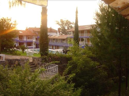 a building with a lot of trees in front of it at Hotel Bella Vista in Huasca de Ocampo
