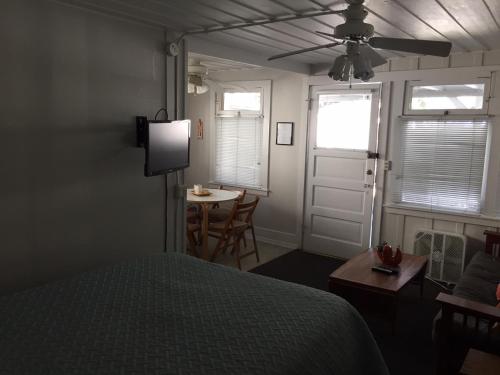 a bedroom with a bed and a table and a window at Catalina Island Seacrest Inn in Avalon