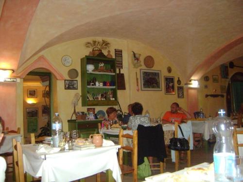 un grupo de personas sentadas en mesas en un restaurante en Sant Efisio, en Lotzorai