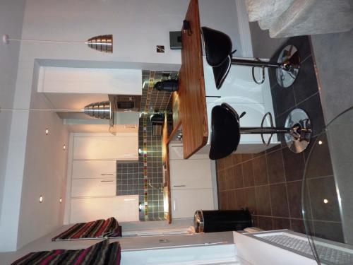 a reflection of a guitar in a mirror in a kitchen at Hewlett Apartments in Cheltenham