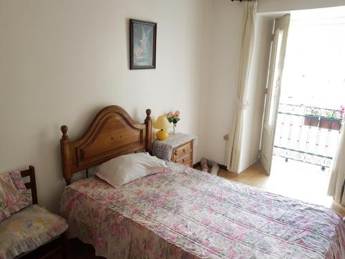 a bedroom with a bed and a window at Residencial Bem Estar in Vila Real