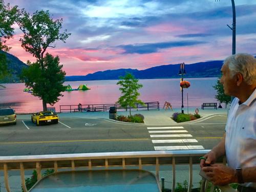 an older man looking out over a parking lot at Black Sea Motel in Penticton