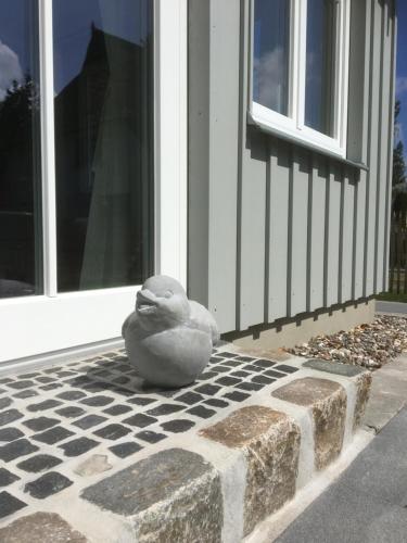 a statue of a duck sitting in front of a door at Wolffs-Idyll in Prerow