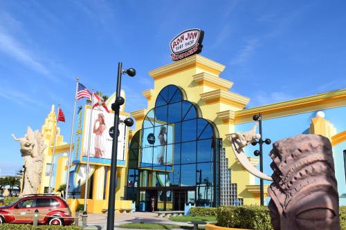 a persons foot in front of a shopping center at Cocoa Beach Towers in Cocoa Beach