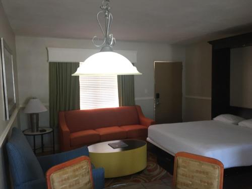 a hotel room with a bed and a couch at Silver Seas Beach Resort in Fort Lauderdale