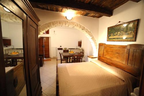 a bedroom with a bed and a dining room at Case Vacanza Al Borgo Antico in Vico del Gargano