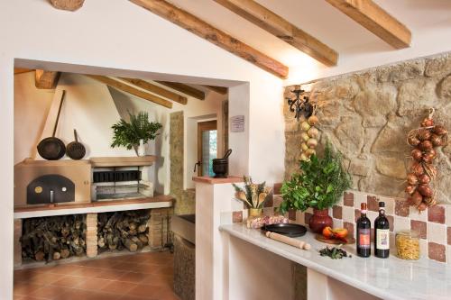 a kitchen with a counter and a stone wall at Casa Vacanze Villa il Castellaccio in Lucolena in Chianti