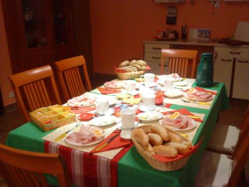 a dining room table with a green and white table cloth at Kupková ubytování v soukromí in Brno