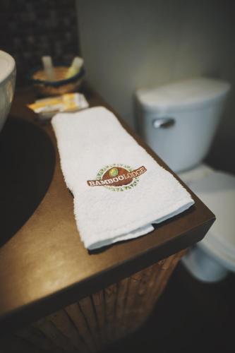 a towel on a counter next to a toilet at Bamboo Lodge Paracas in Paracas