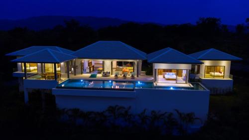 a house with a swimming pool at night at Villa Bella in Bophut 