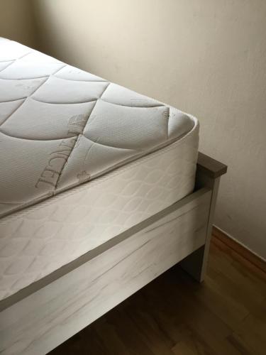 a mattress sitting on a bed frame in a room at Soós Apartman in Balatonfüred