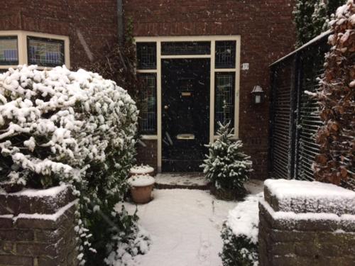 a house with a door covered in snow at Florentino in Eindhoven