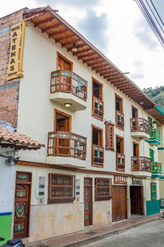 a building with wooden doors and balconies on it at Hotel Atenas Jericó in Jericó