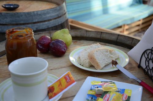 a table with a plate of cake and fruit on it at Hostal Vitalia in Santiago