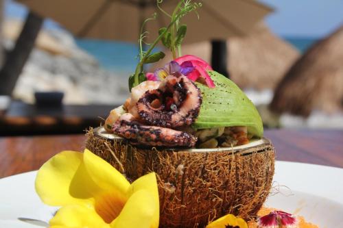 a close up of a coconut sandwich on a table at Maria Del Mar Tulum - Adults Only in Tulum