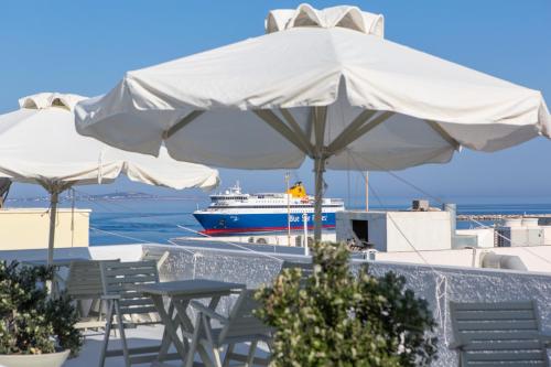a white boat sitting on top of a sandy beach at Lygdamis Hotel in Naxos Chora