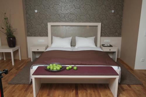 a bedroom with a bed with a bowl of fruit on a table at Gasthof & Hotel Wolfsegger in Engerwitzdorf