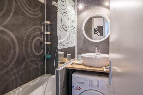 a bathroom with a sink and a washing machine at Au Pied Du Mont-Blanc - Chamonix in Chamonix-Mont-Blanc