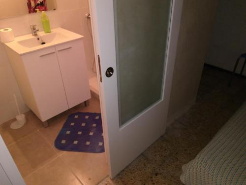 a bathroom with a sink and a shower backdoor at Casa Roja in Las Palmas de Gran Canaria